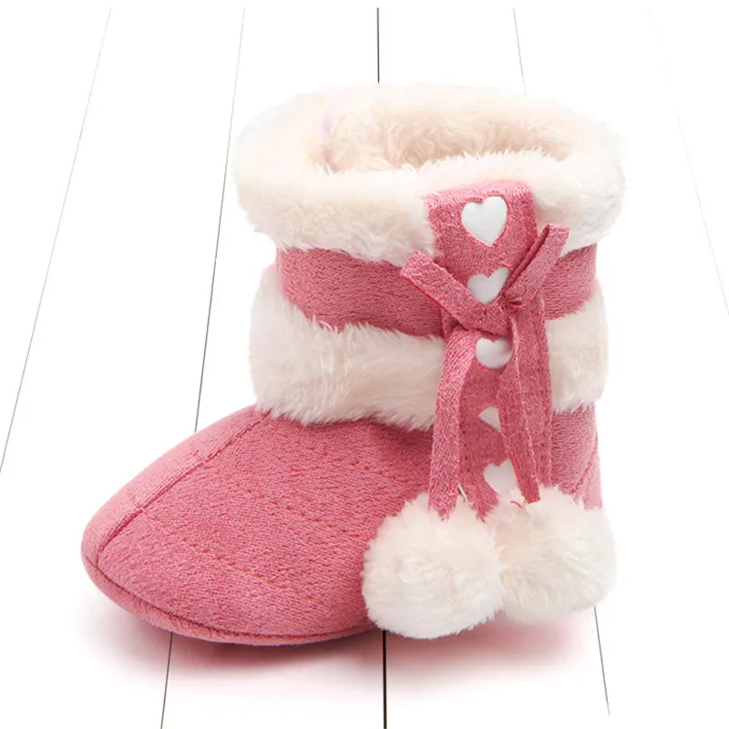 Rose pink baby winter boots with plush lining, heart detailing and fluffy pom poms