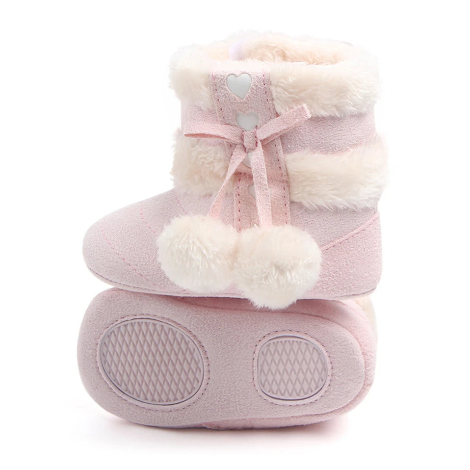 Heart Slipper Boots for babies in blush pink, featuring fluffy pom poms and heart details