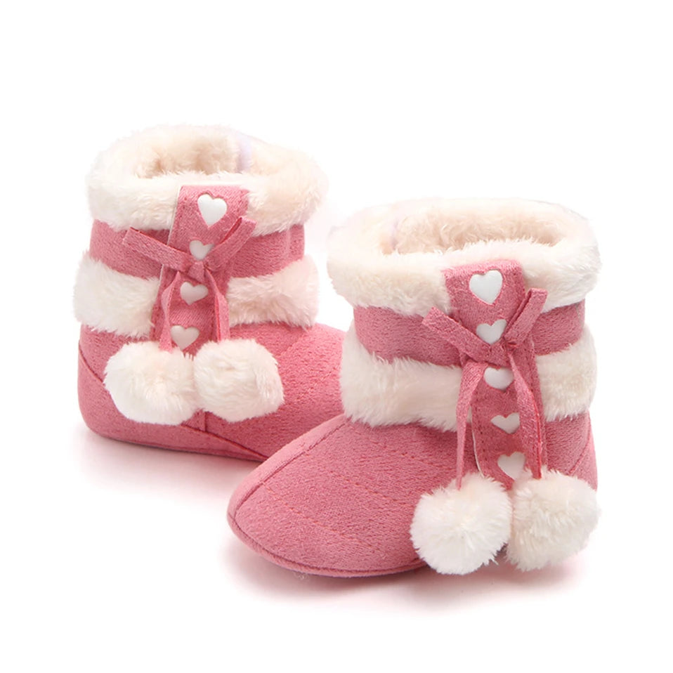 Rose pink Heart Slipper Boots for babies with faux fur lining and fluffy pom poms, perfect for winter comfort.
