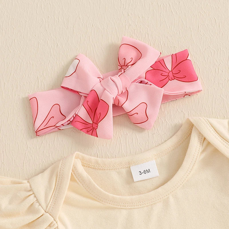 Pink bow headband with playful bow print for baby girl’s outfit, part of My First Father’s Day Ruffle Set.