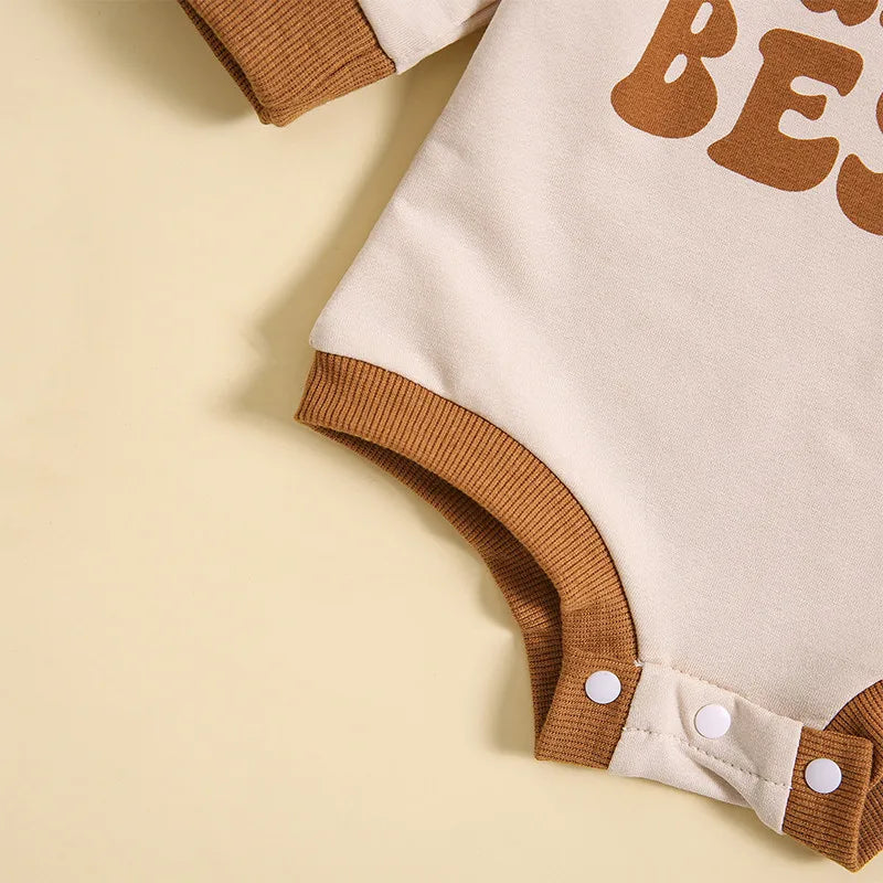 Auntie's Bestie Romper detail showing retro print and snap fastenings