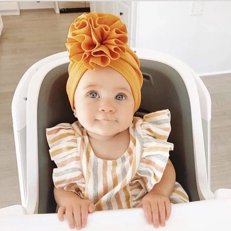 Baby girl wearing a mustard flower turban from Lulu Babe