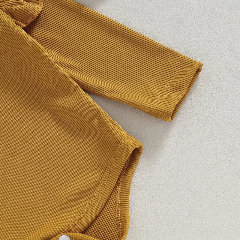 Close-up of mustard long sleeve ruffle romper for baby girls, featuring soft ribbed fabric