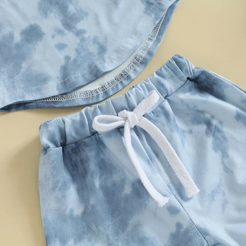 Close-up of the Tie Dye Shorts Set featuring light blue short-sleeve tee and matching elastic-waist shorts.