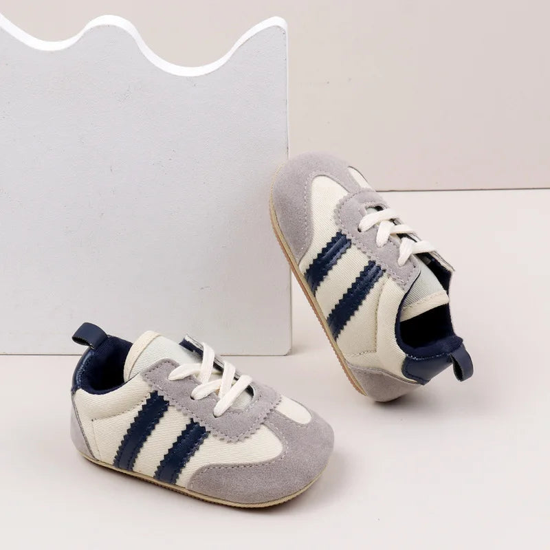 Classic Stripe Baby Sneakers in grey with navy stripes, perfect for stylish tiny feet aged 0-18 months.