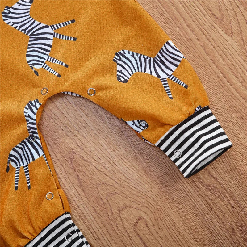 Mustard zebra onesie featuring playful zebra print and striped cuffs, perfect for babies and toddlers.