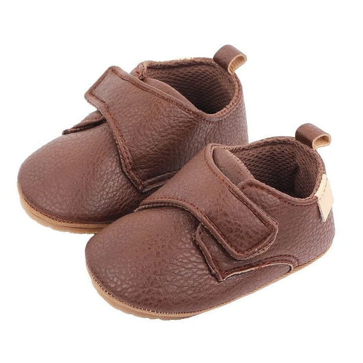 Brown vegan leather baby shoes with wide velcro strap, textured grain and pull tab