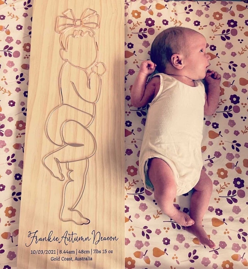 Personalised birth plaque beside a newborn baby, showcasing a unique 3D baby outline design and birth details.
