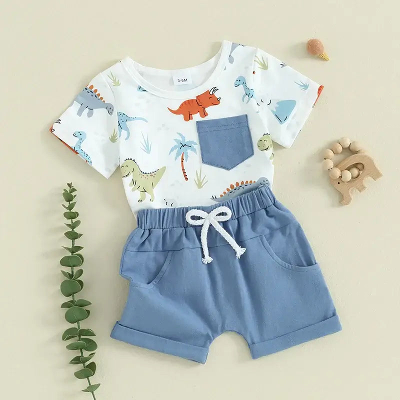 Baby boy dinosaur outfit set with t-shirt and blue shorts, styled flat lay