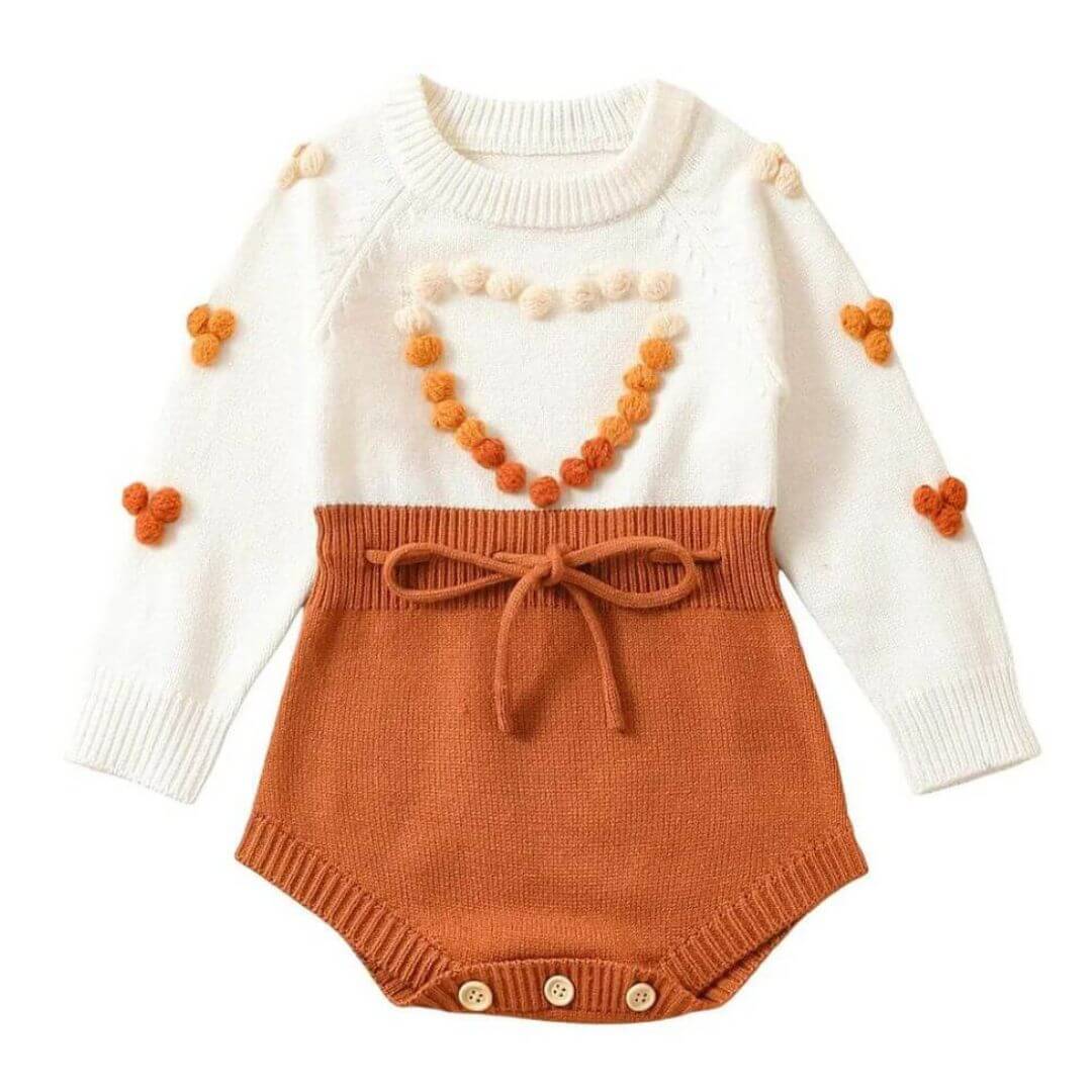 Knit baby girl romper with pom pom heart, in cream and cinnamon