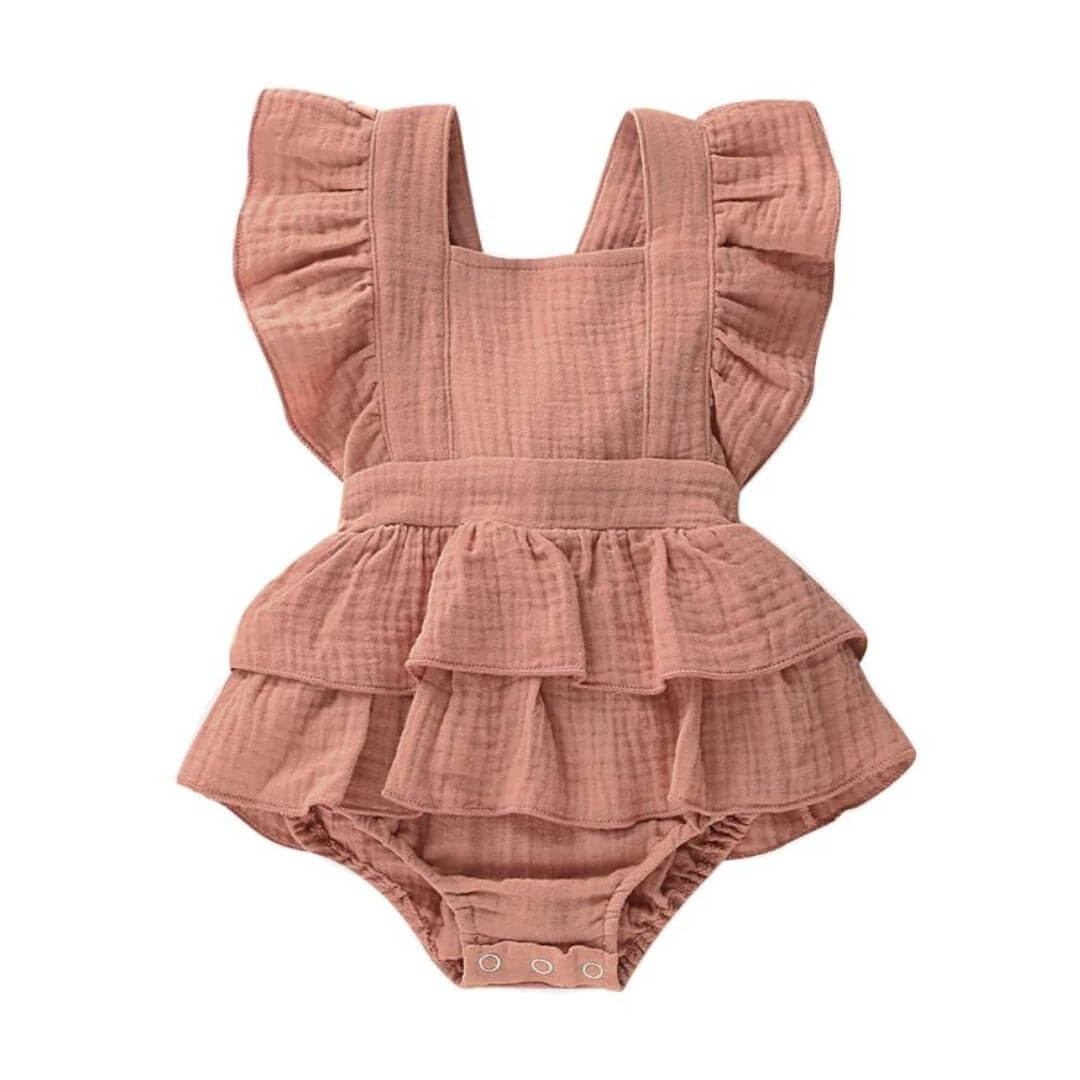Jennifer Ruffle Baby Girl Romper in dusty peach featuring shoulder ruffles and backless design