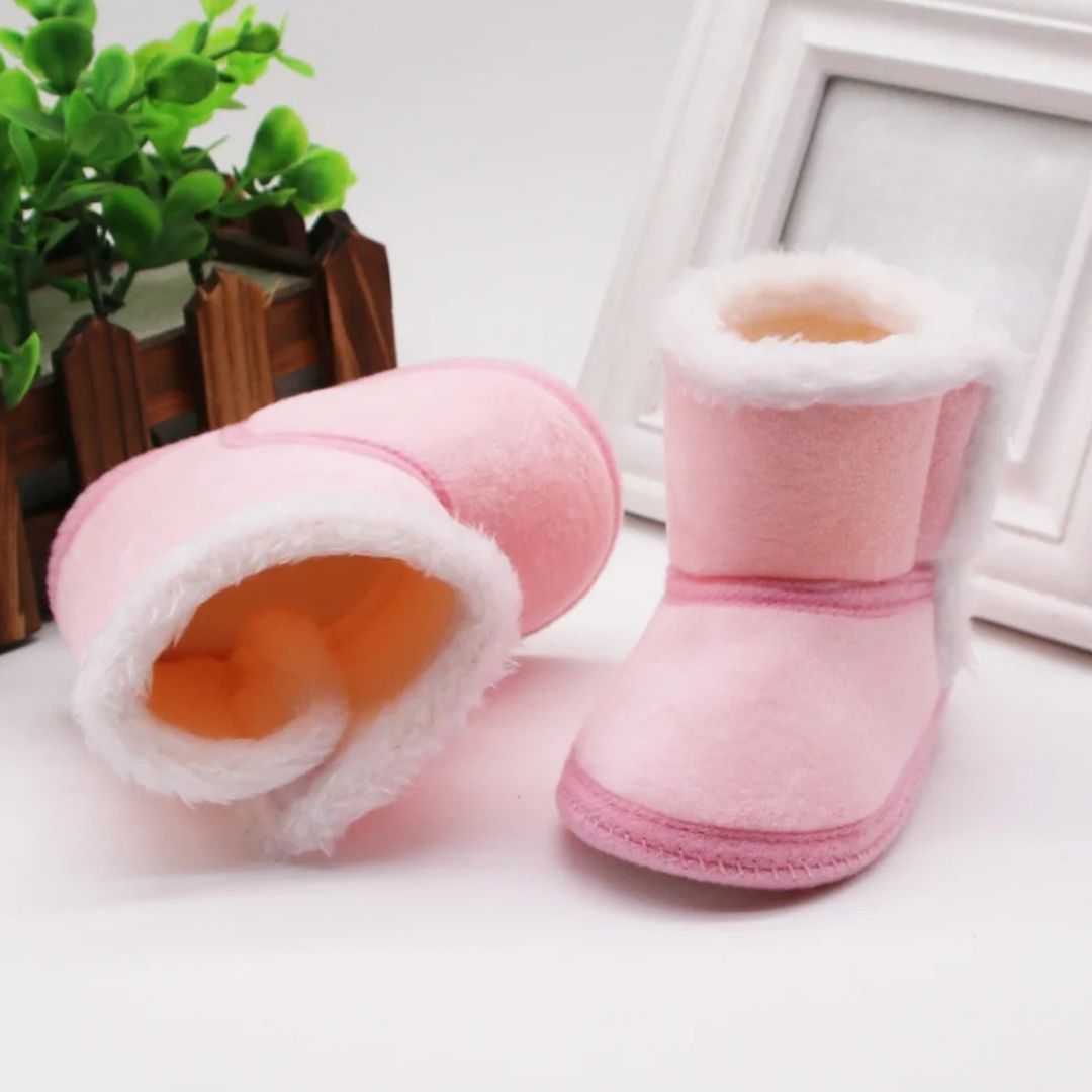Soft pink baby slipper boots with fluffy lining, perfect winter baby booties for tiny toes.