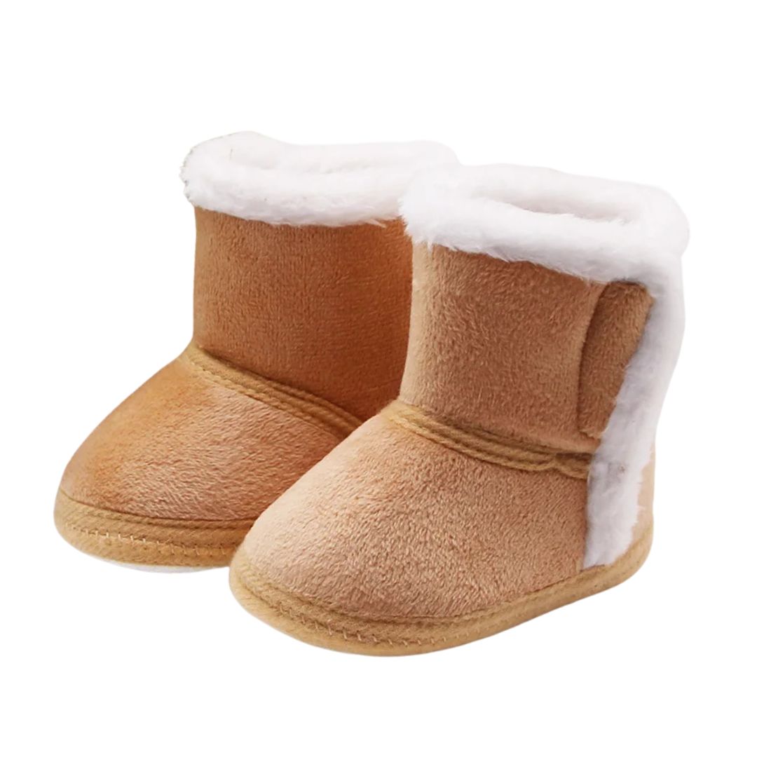 Tan baby slipper boots with fluffy lining, perfect for keeping tiny toes warm during winter outings.