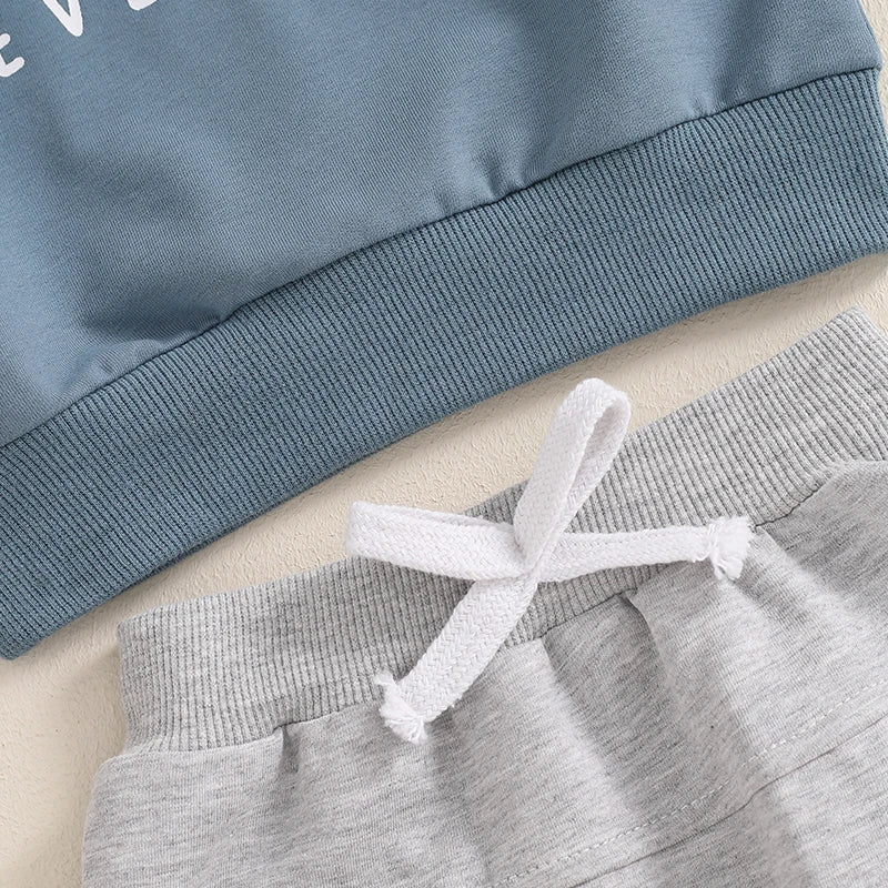 Closeup of "A little dirt never hurt" baby boy set in blue and grey