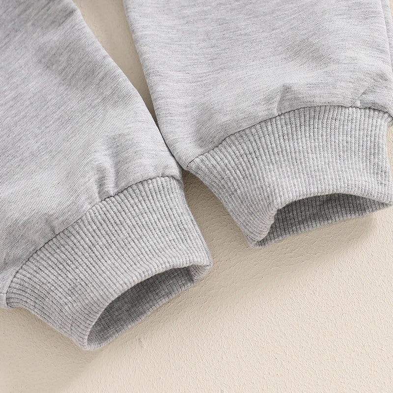 Closeup of grey cuffs from baby boy tracksuit