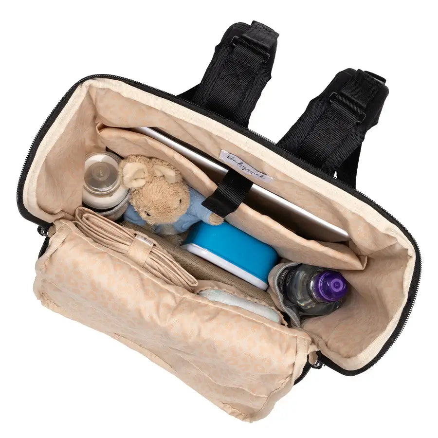 Interior view of the Babymel Finn nappy backpack, showcasing ample storage for bottles, toys, and essentials.