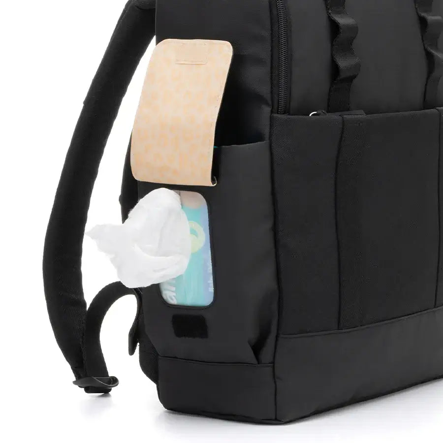 Close up of Babymel Finn nappy backpack in black with Easy-wipes side pocket.