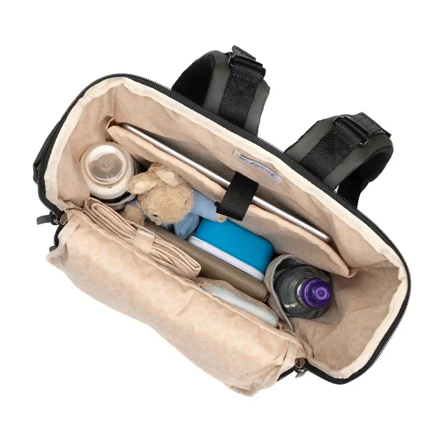 Inside view of the Babymel Finn nappy backpack in olive, featuring organised compartments for bottles and essentials.