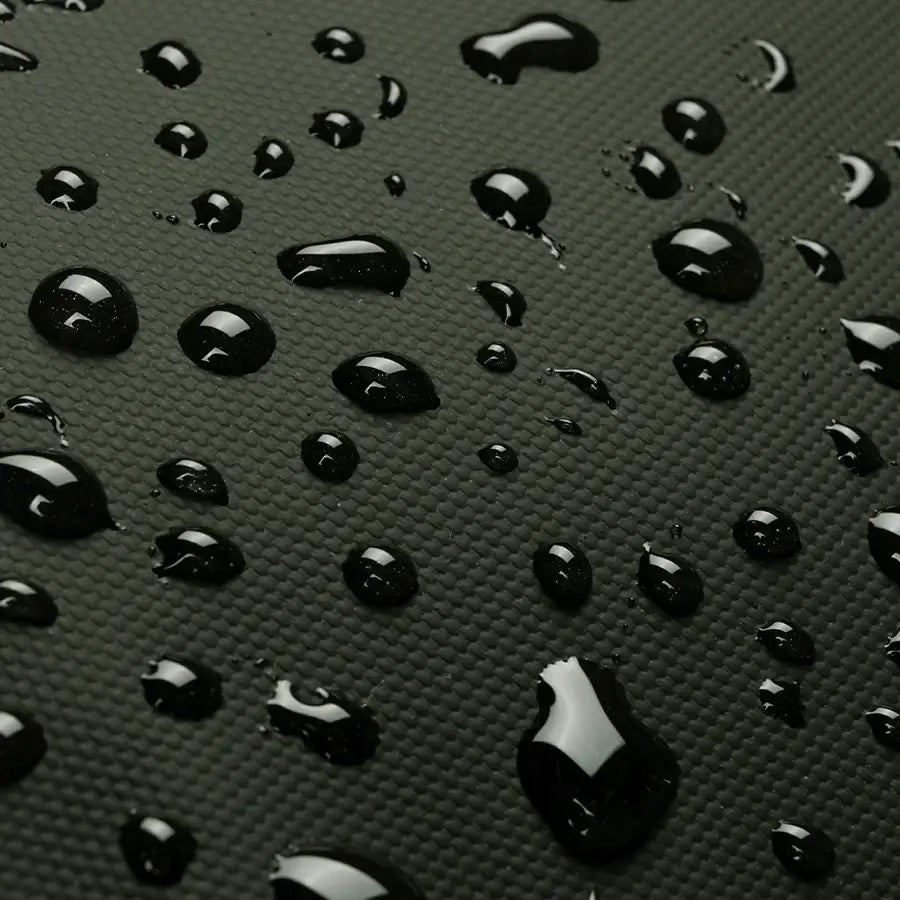 Close-up of droplets on fabric, showcasing the Finn Nappy Bag's waterproof design.