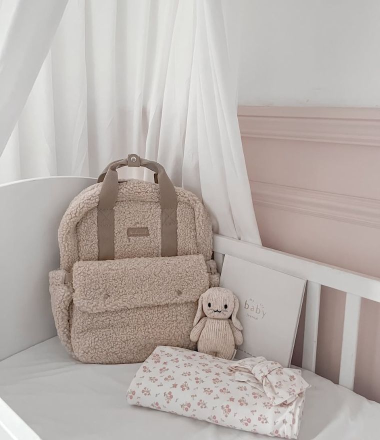 Babymel teddy nappy backpack, pictured in baby nursery