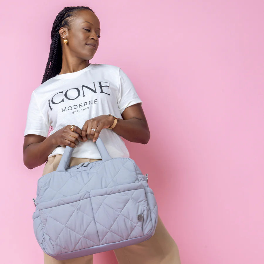Babymel Willow Nappy Bag in duckegg grey - lifestyle image of a mum using the bag