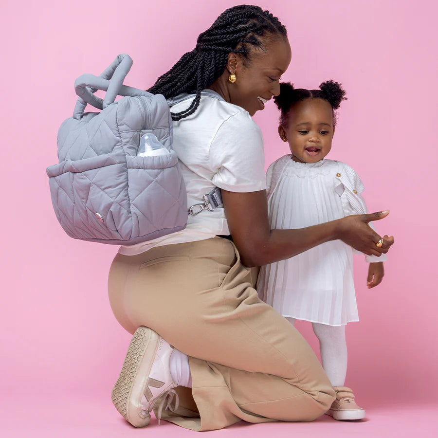 Mum wearing Babymel Willow Nappy Bag in grey as a backpack