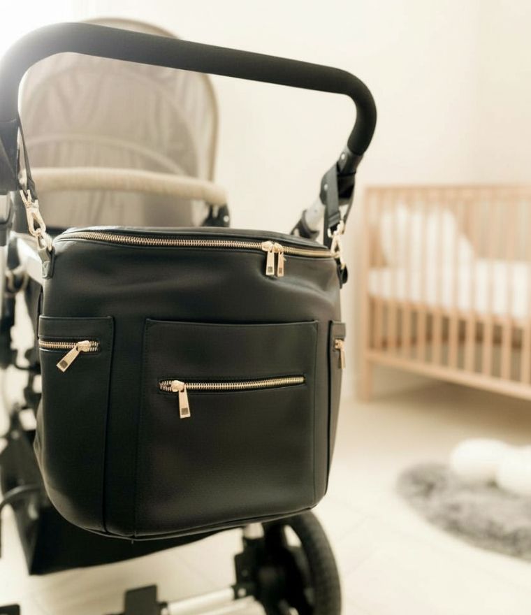 Brooklyn vegan leather nappy bag hanging attached to pram