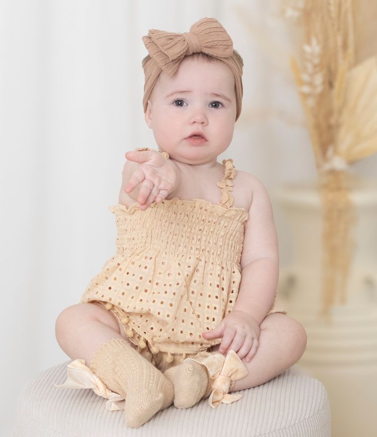 Baby girl modelling Celeste boho lace outfit in beige - Lulu Babe
