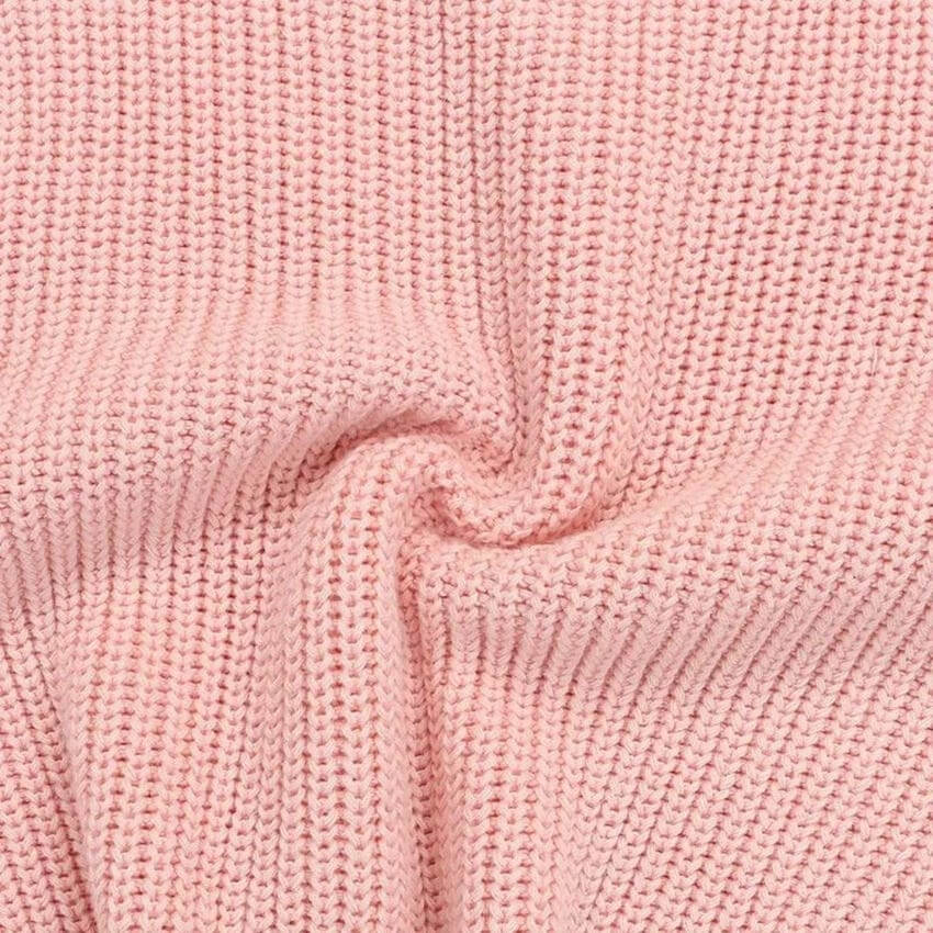 Close-up of pink baby jumper showing the knitted fabric