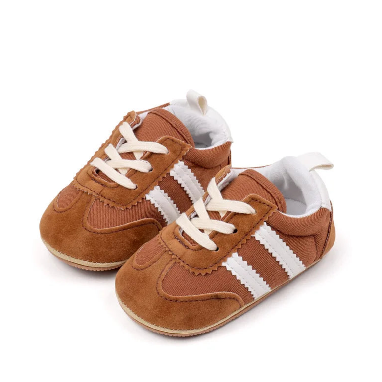 Classic stripe baby sneakers in warm brown, perfect for stylish little feet aged 0-18 months.
