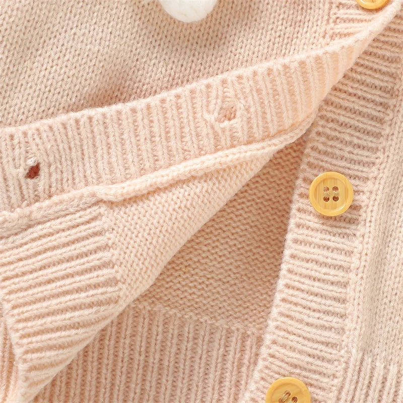 Close-up of beige daisy floral cardigan for baby & toddler girls