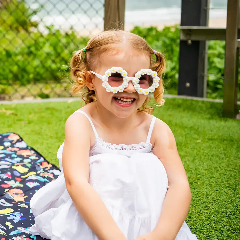 Girl wearing Daisy Toddler Sunglasses in white & yellow | Little Renegade Company