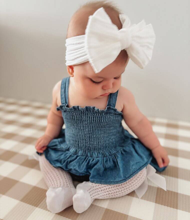 Baby girl wearing Denim Peplum Romper from Lulu Babe (comes in 0-3 months, 3-6 months, 6-12 month & 12-18 months)