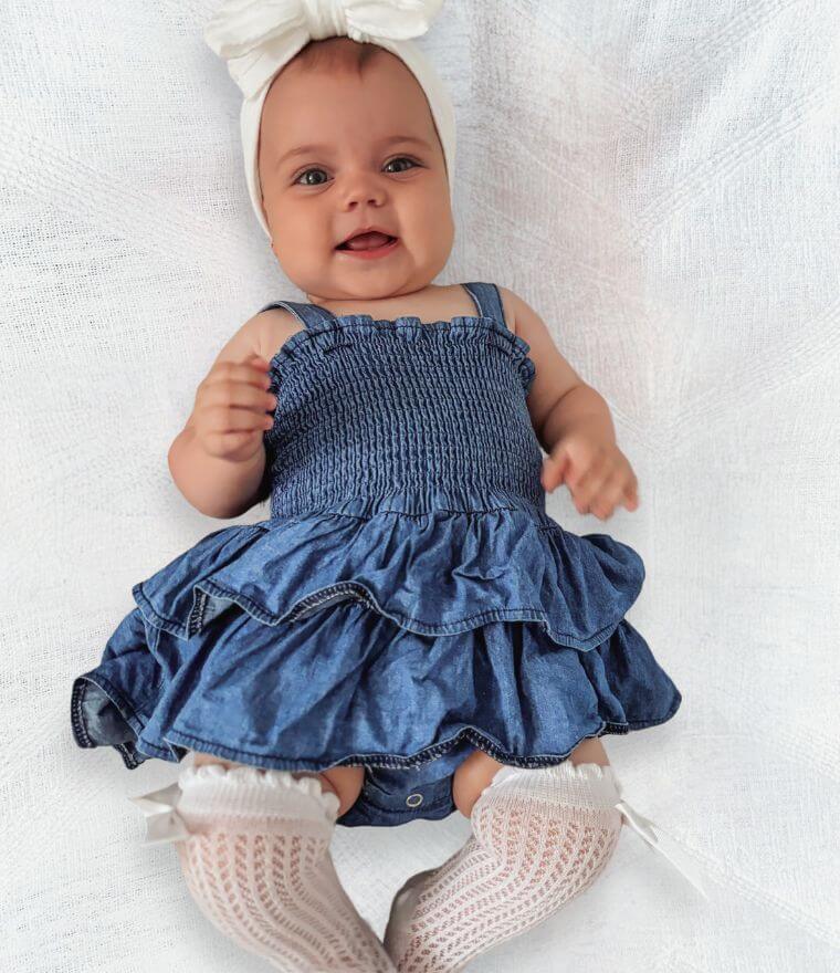 Baby girl wearing Denim Peplum Romper from Lulu Babe (comes in 0-3 months, 3-6 months, 6-12 month &  12-18 months)