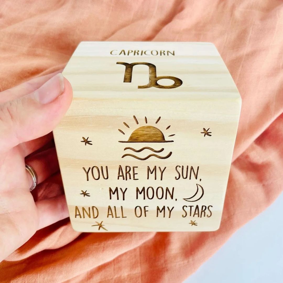 Personalised wooden birth stats block showing star sign name, symbol and boho sun engraving on natural pine cube