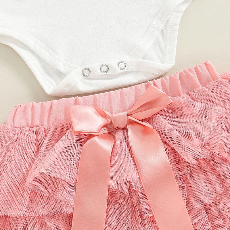 Closeup of pink tutu skirt with satin bow from first birthday set