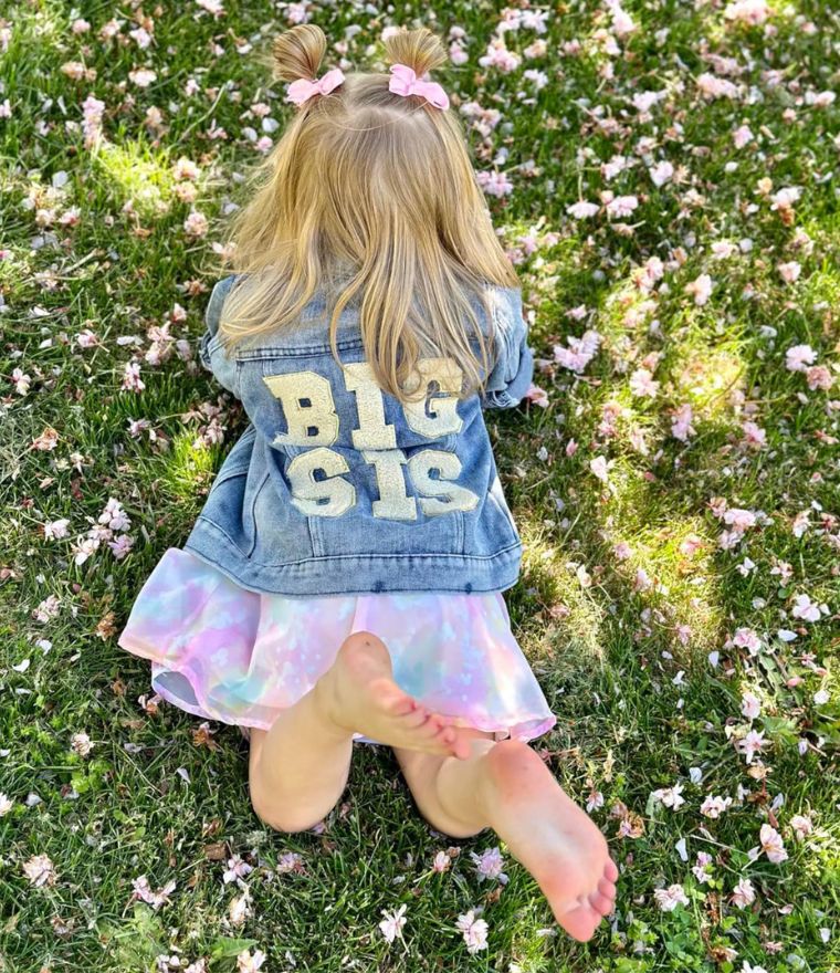 Girl wearing Big Sis Denim Jacket outdoors