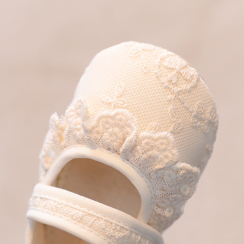 Floral embroidered lace detail on ivory baby shoes for christenings and special occasions