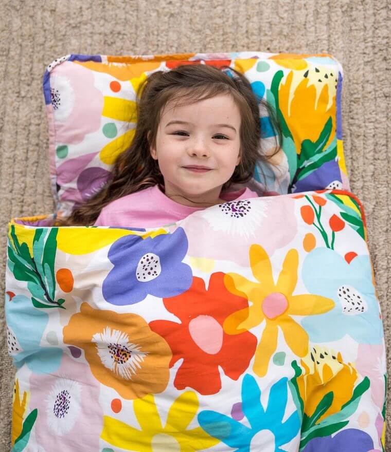 Girl in toddler nap mat - portable kids nap mat in vibrant floral print