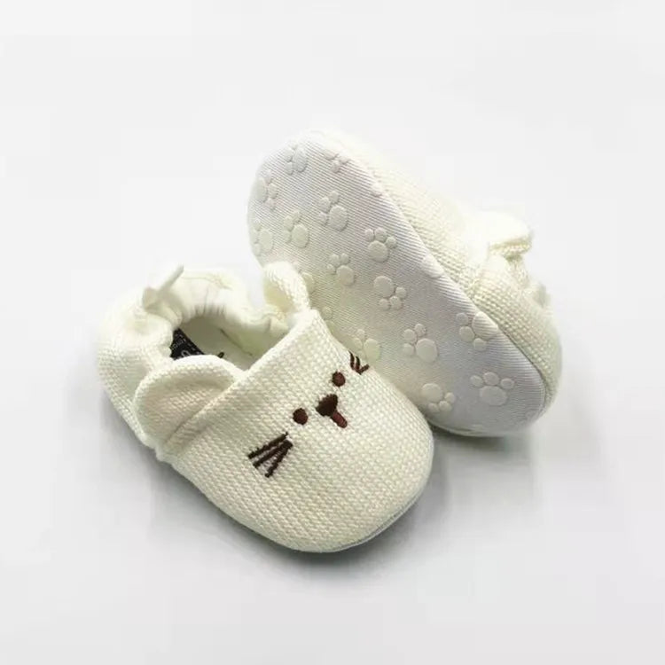 Cream knitted cat baby booties with 3D ears and embroidered details