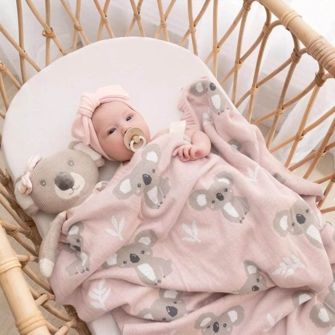 Baby snuggled in pink koala baby blanket