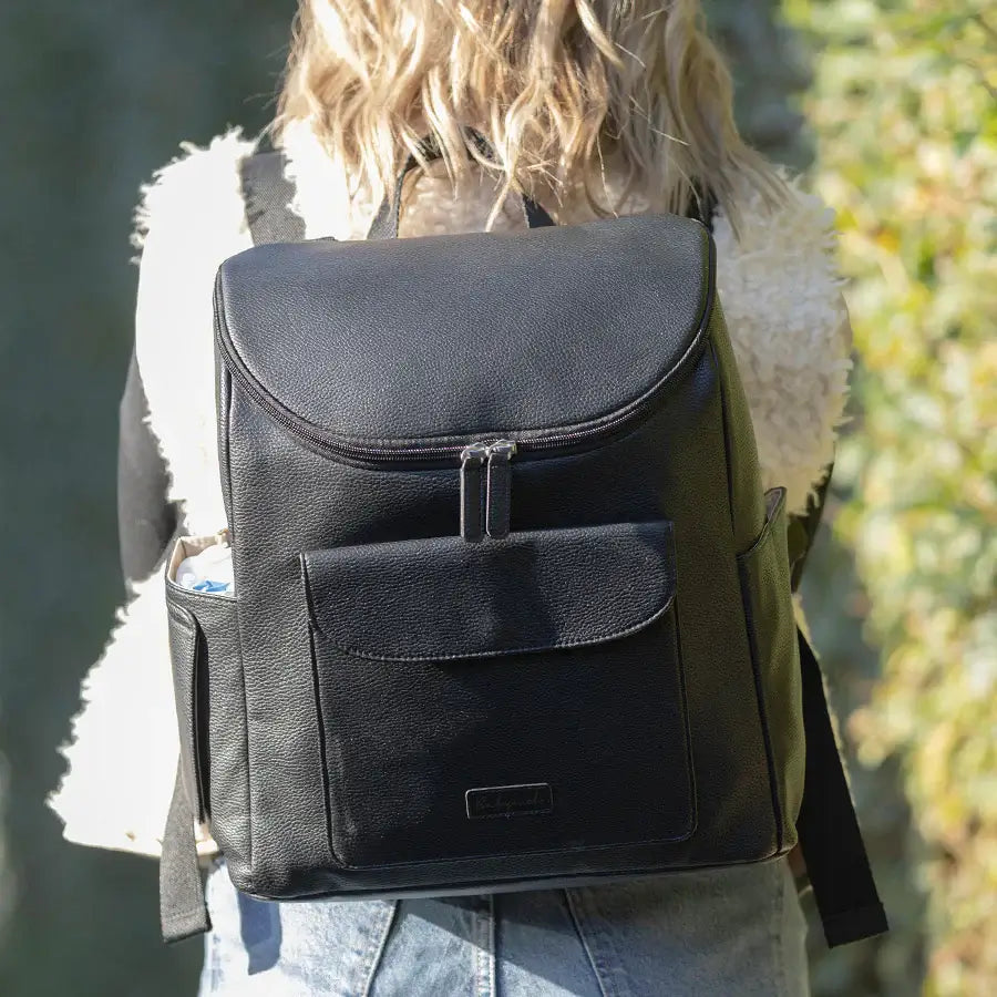 Mum holding Babymel Lennox Nappy Backpack in black