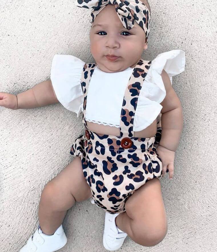 Baby girl wearing Leopard Pinafore Romper with matching headband
