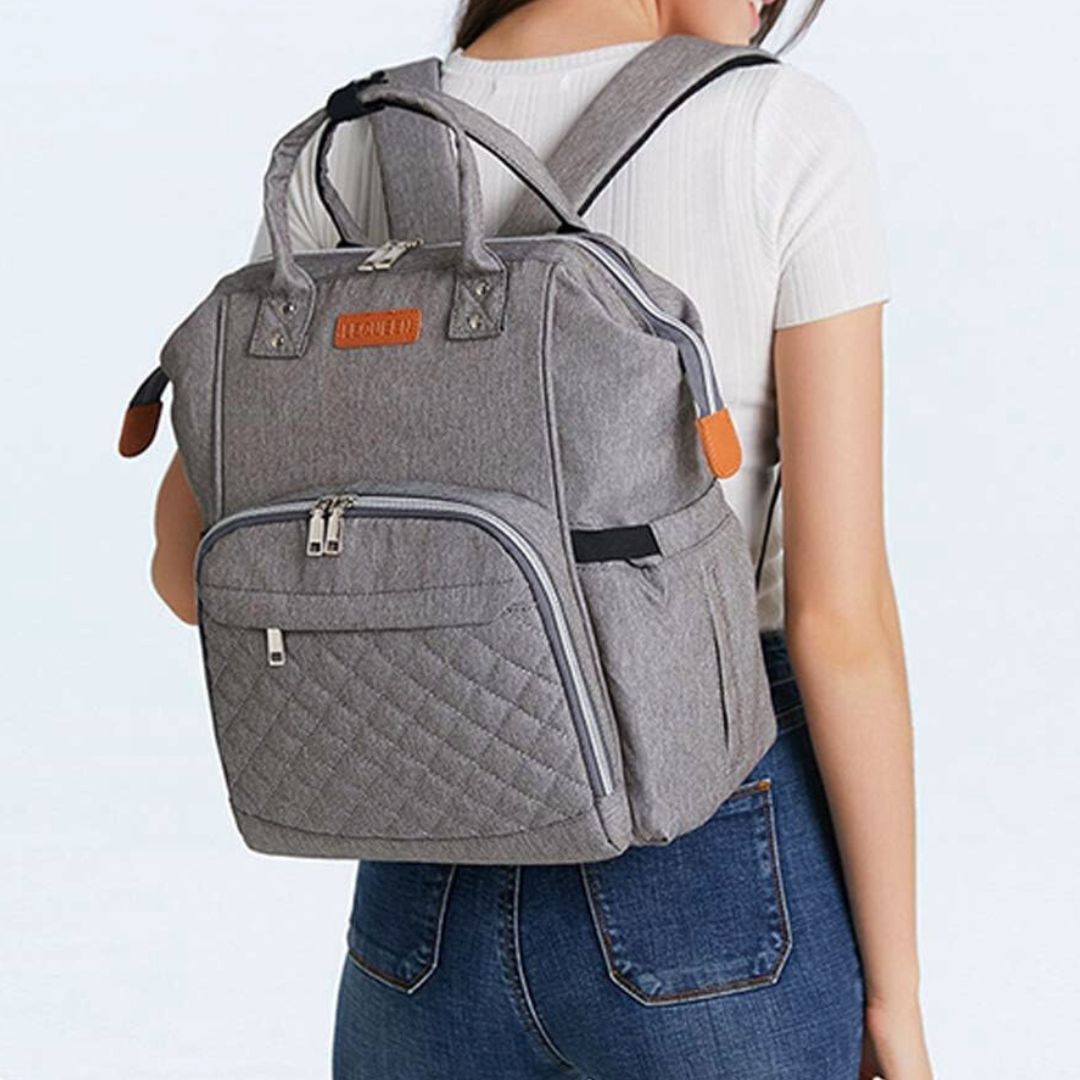 Mum wearing LeQueen Quilted Nappy Backpack in grey