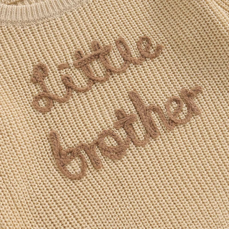 Little brother jumper in beige, closeup image of embroidery