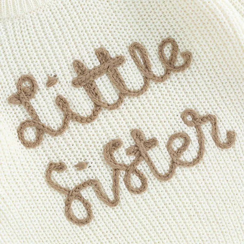 Closeup of embroidery in Little Sister white knit jumper