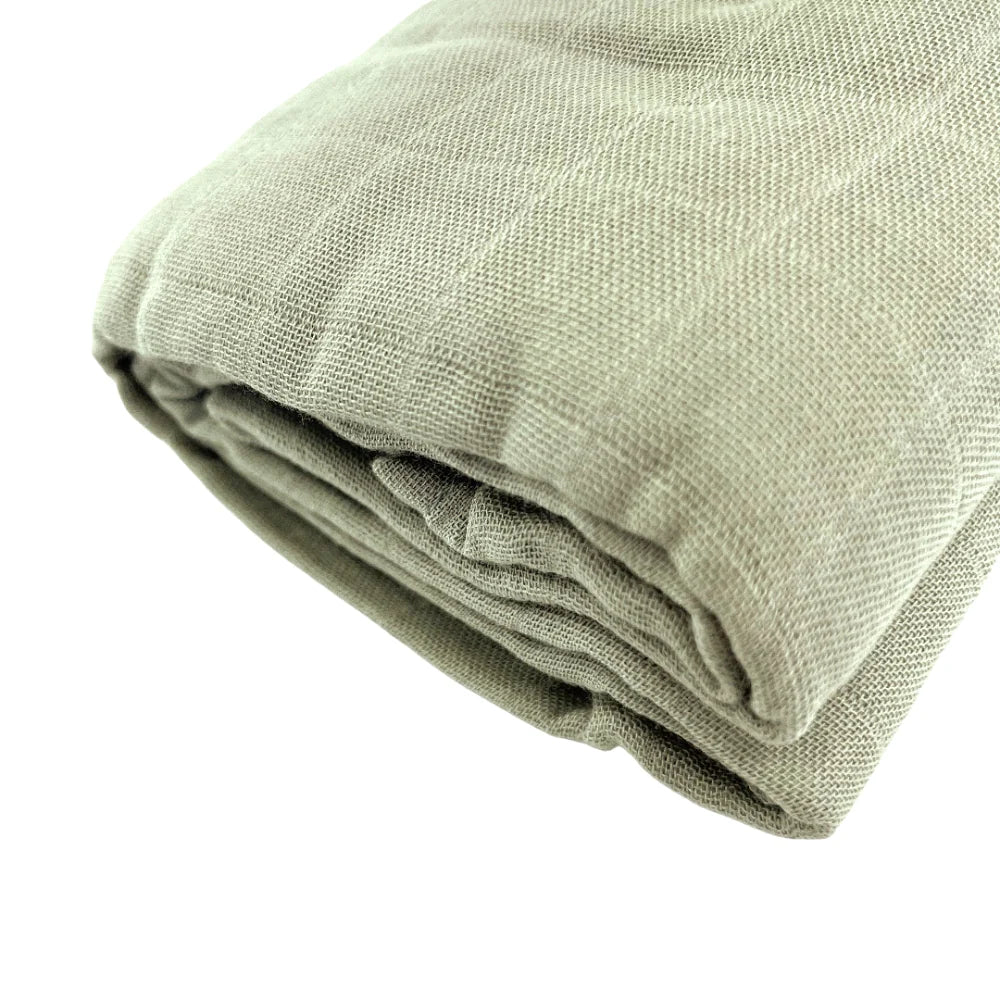 Closeup of sage green muslin baby wrap by Little Renegade Company