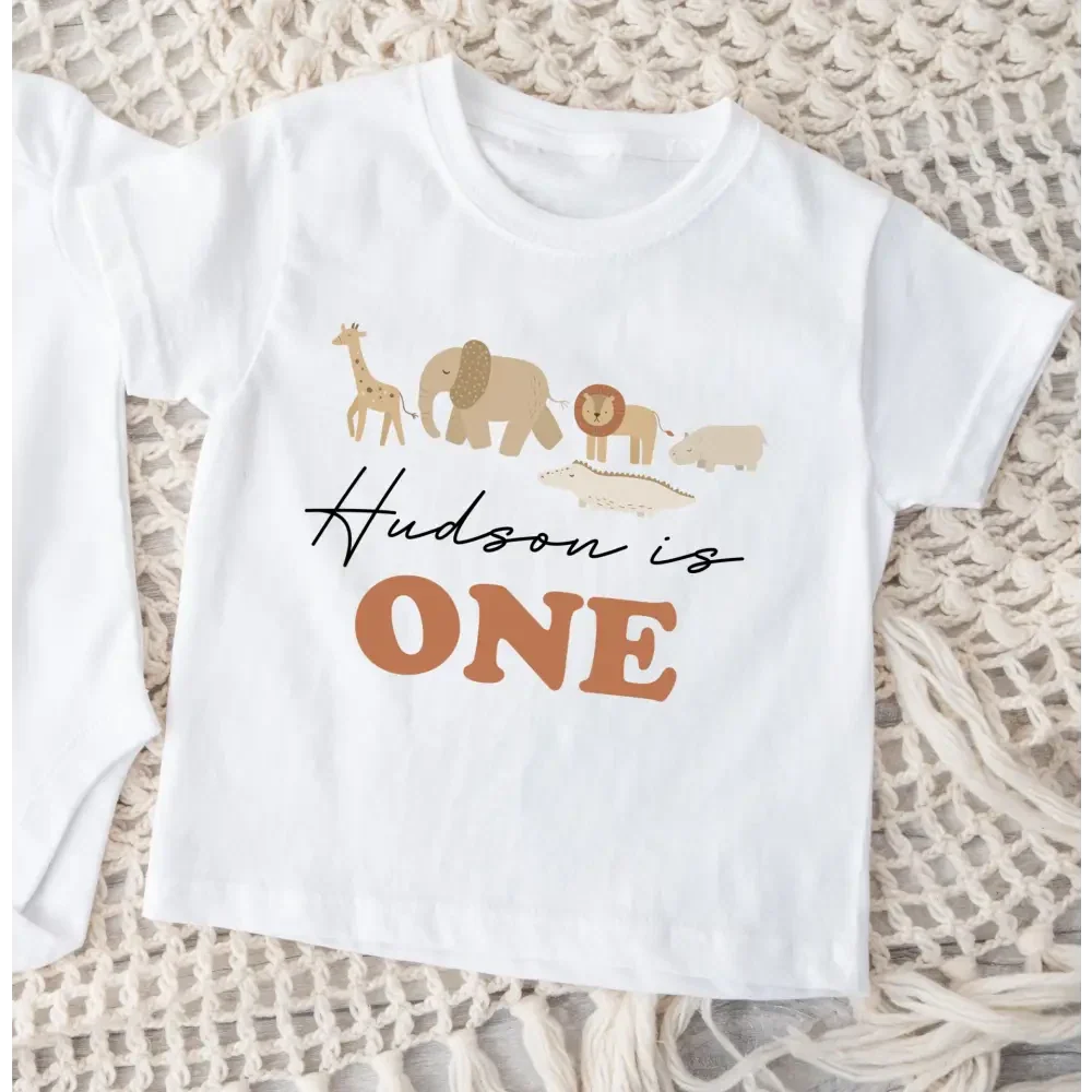 Baby boy personalised first birthday t-shirt with safari animals and "Hudson is One" text