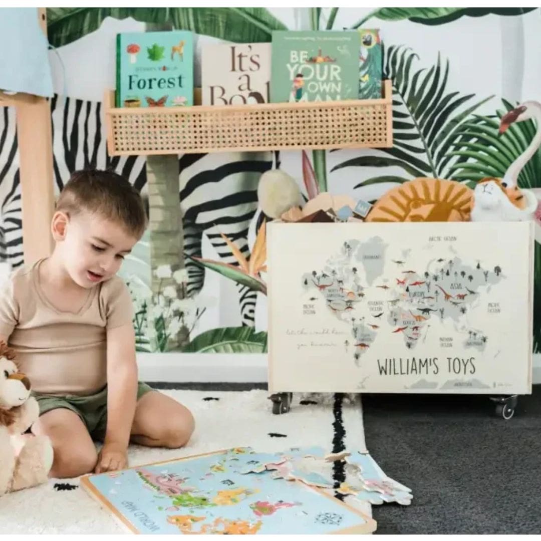 A child playing on the floor next to a Personalised Wooden Toy Box