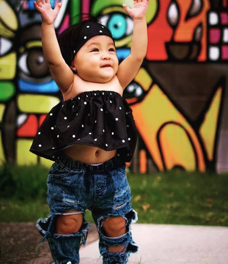 Toddler girl wearing trendy jeans and sleeveless polka dot top from Lulu Babe